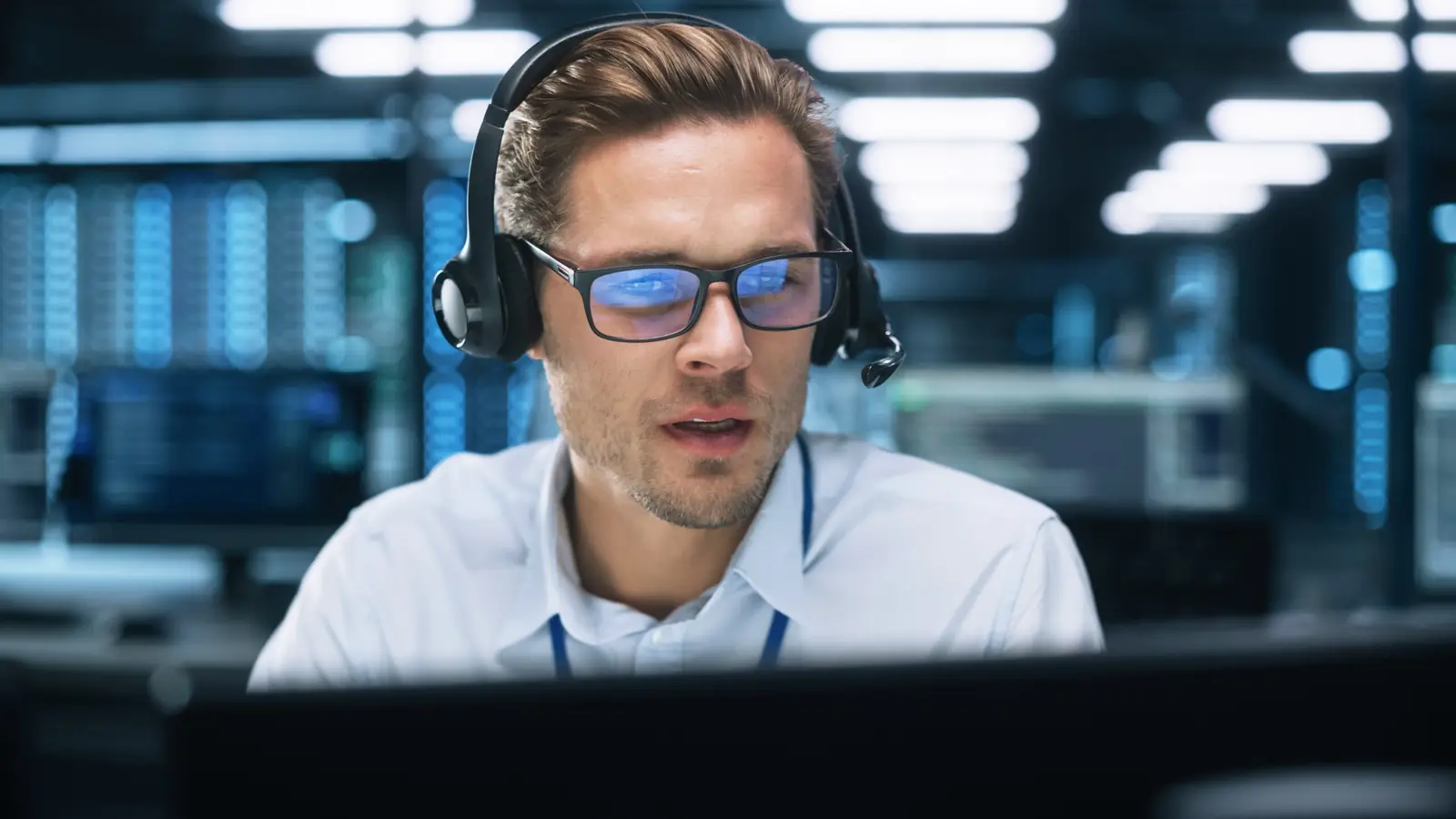 Engineer with a headset working at a computer